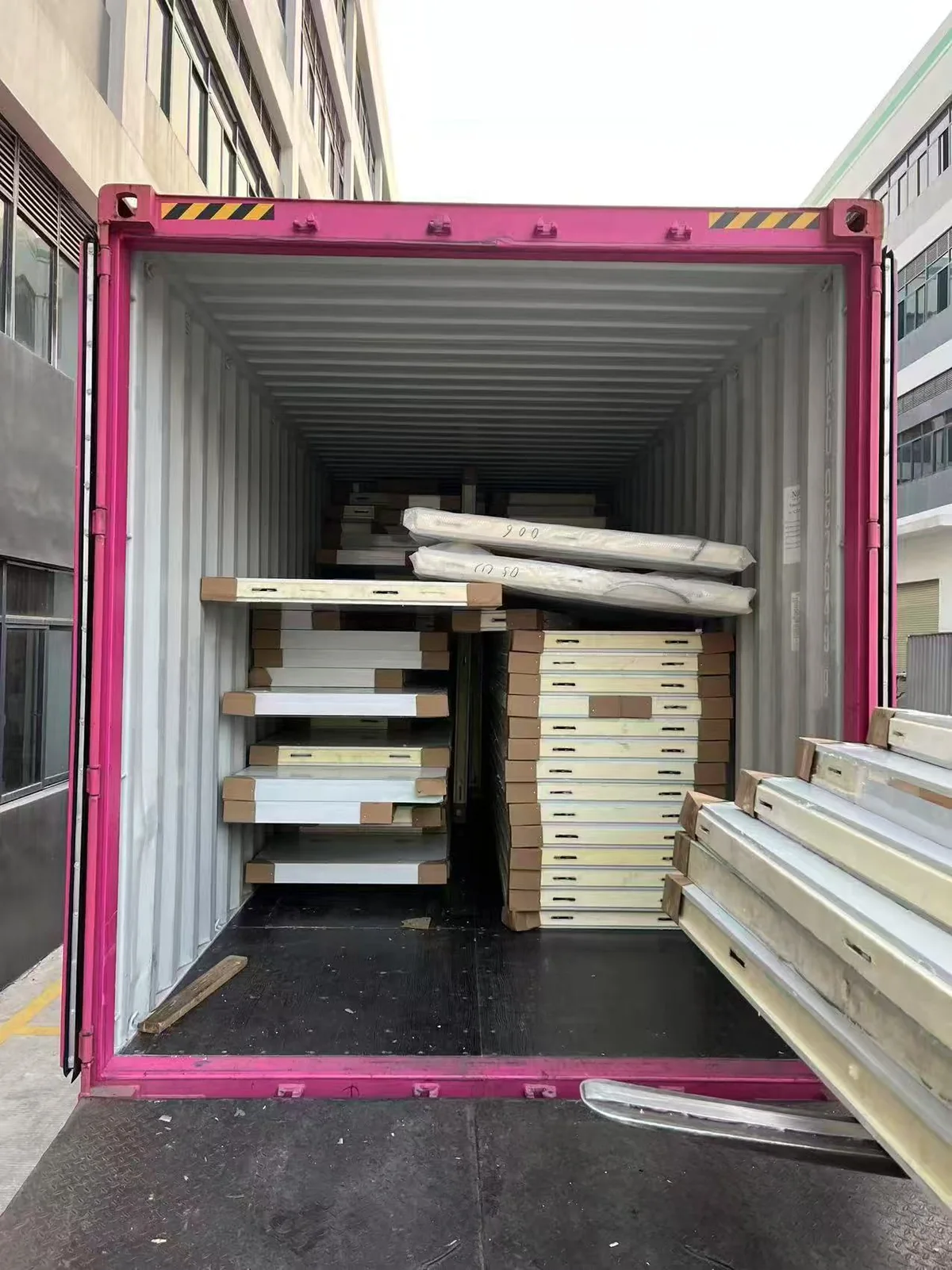 Packed doors and building materials inside an open shipping container
